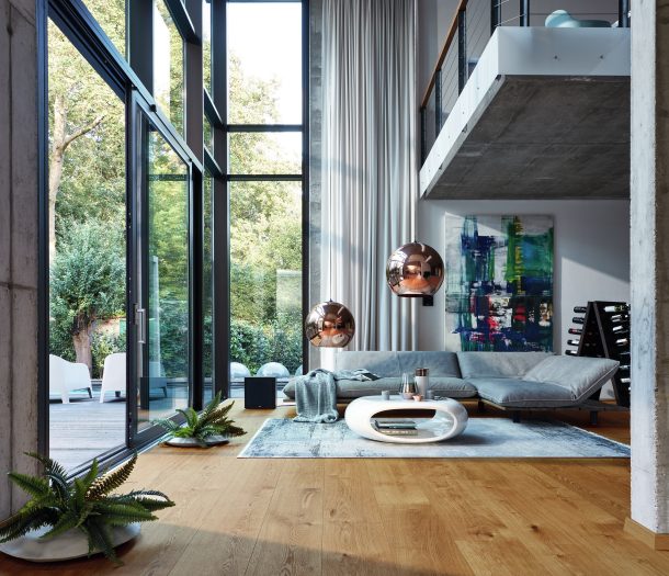 Woonkamer in industriele stijl met hoge ramen, hoekbank en Meister houten vloer Woonkamer in industriele stijl met hoge ramen, hoekbank en Meister houten vloer
