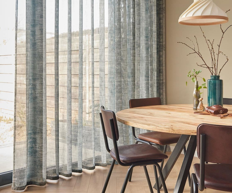 Licht grijze/blauwe vitrages in de eethoek